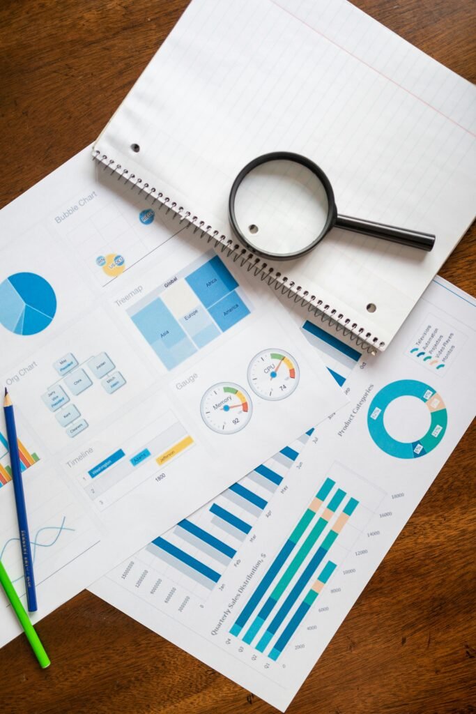 pexels-photo-7948058-7948058 A set of financial charts and graphs with a magnifying glass, perfect for business reports.